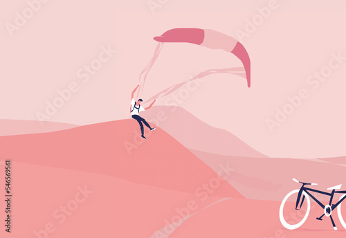 A paraglider in the sky flying over pink mountains is landing  on the spot where he parked his bike  (ID: 546569561)