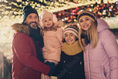 Photo of four cheerful positive people have good mood advent atmosphere city center illumination outdoors