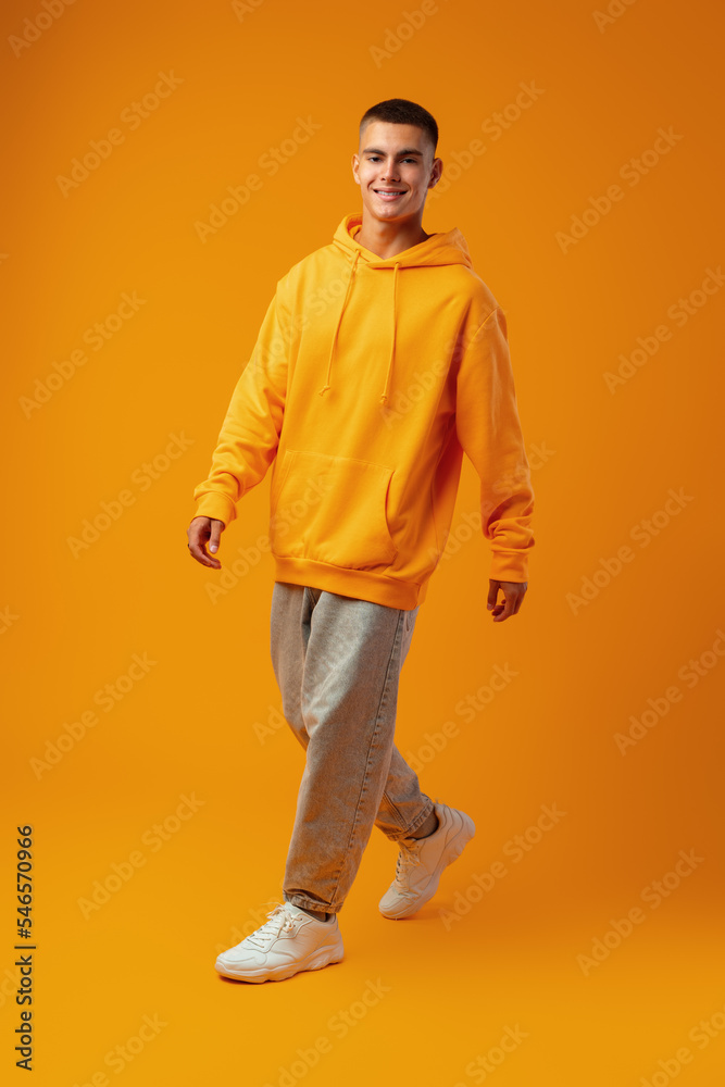 Full length portrait of young man standing on yellow background Full length portrait of young man standing on yellow background