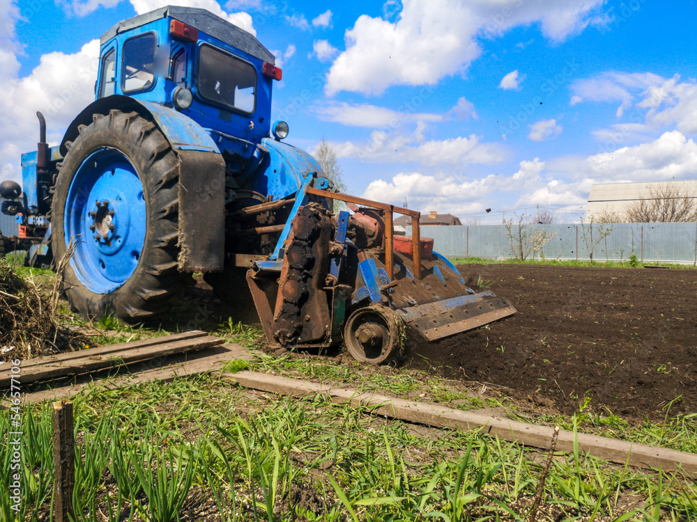 Obraz premium The tractor plows the soil on the field