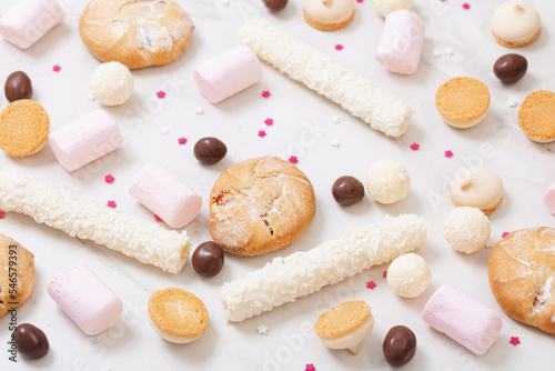 candies and cookies on white marble background