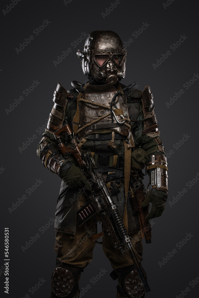 Shot of post apocalyptic soldier dressed in armour and gas mask holding shotgun. Shot of post apocalyptic soldier dressed in armour and gas mask holding shotgun.