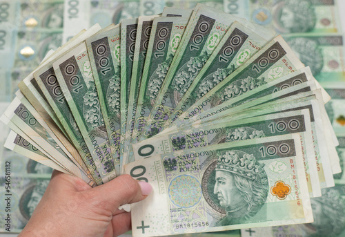 Polish money in hand, fan of hunderd polish zloty notes cash, plenty off 100 polish notes, Poland’s legal tender, rich in poland, złotówki, polskie złote, PLN photo
