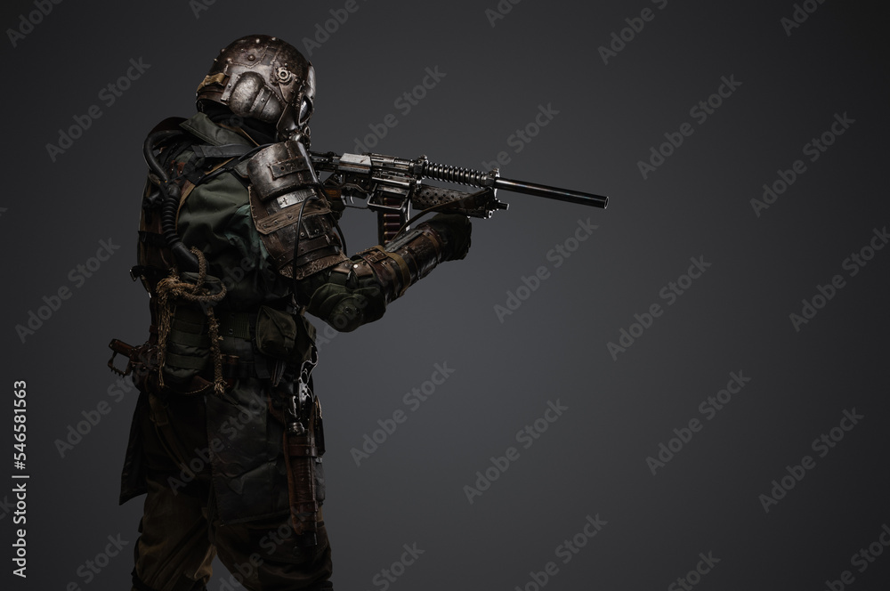 Portrait of military man in post apocalypse style dressed in armored suit aiming shotgun. Portrait of military man in post apocalypse style dressed in armored suit aiming shotgun.