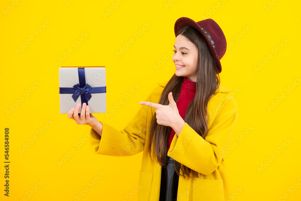 Happy teenager portrait. Child with gift present box on isolated background. Presents for birthday, Valentines day, New Year or Christmas. Smiling girl. Happy teenager portrait. Child with gift present box on isolated background. Presents for birthday, Valentines day, New Year or Christmas. Smiling girl.