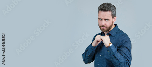 Using force in self-defense. Standing in defensive position. Fighting defensive action. Man face portrait, banner with copy space.