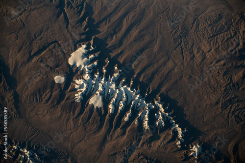 Aerial view of the Tanggula Mountains close to Hala Lake in western China. Snowcapped Mountains. Elements of this image furnished by NASA.  photo