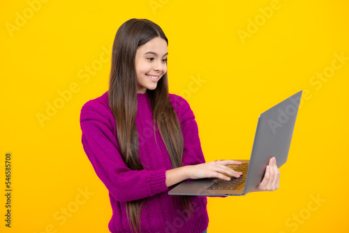Teenager school girl hold notebook laptop. School children on isolated studio background.
