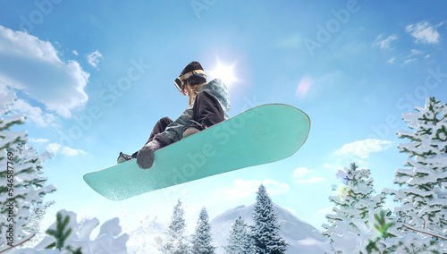 Snowboarder girl in action. Extreme winter sports.