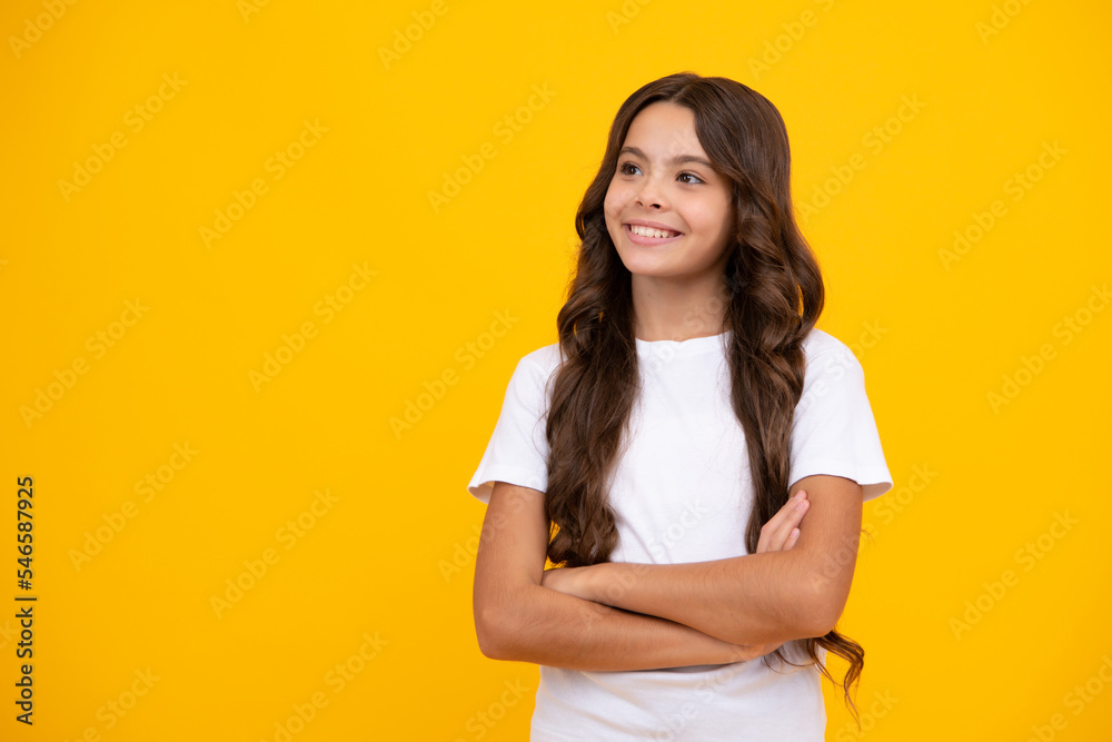 Confident child keep arms crossed, isolated on yellow background, empty space. Little caucasian teenage girl 12, 13, 14 years old hold hands crossed. Children studio portrait. Childhood lifestyle. Confident child keep arms crossed, isolated on yellow background, empty space. Little caucasian teenage girl 12, 13, 14 years old hold hands crossed. Children studio portrait. Childhood lifestyle.