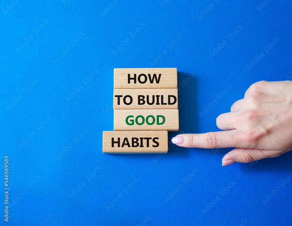 How to build good habits symbol. Concept words How to build good habits on wooden blocks. Beautiful blue background. Businessman hand. Business and How to build good habits concept. Copy space. How to build good habits symbol. Concept words How to build good habits on wooden blocks. Beautiful blue background. Businessman hand. Business and How to build good habits concept. Copy space.