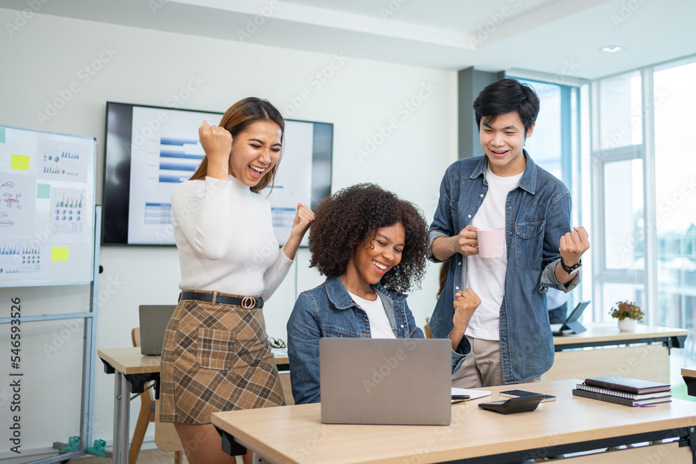 Group of young Asian businessmen are happy work together as a team and achieve goals excited about the work of raising hands to congratulate colleagues in the office.