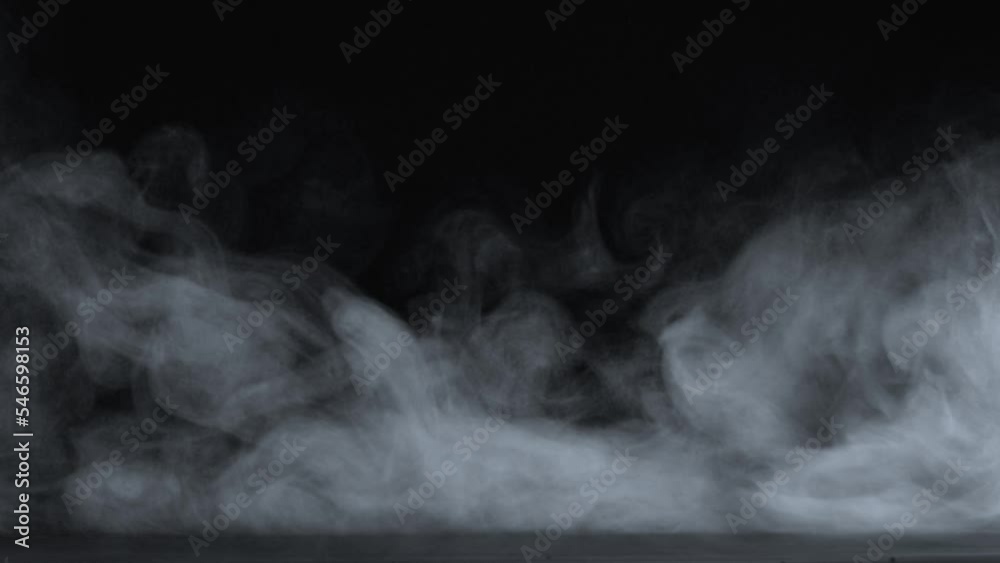 Abstract white smoke in slow motion. Smoke, Cloud of cold fog in light spot background. Light, white, fog, cloud, black background, 4k, ice smoke cloud. Floating fog.