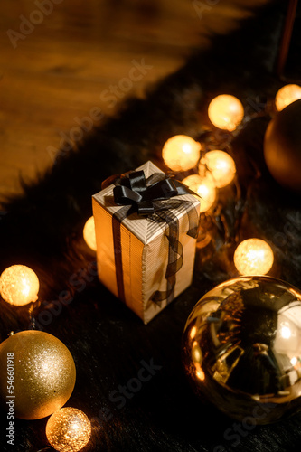 Merry Christmas and Happy Holidays!Beautiful black modern living room decorated for Christmas.Chrystmas Luxury black style living room interior with sofa decorated chic , golden style.Selective focus.