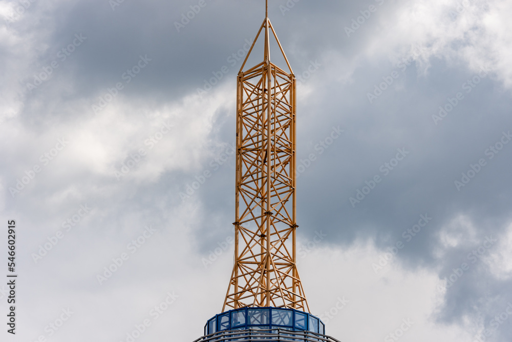 Big yellow lightning rod tower on the roof of a modern building Big yellow lightning rod tower on the roof of a modern building