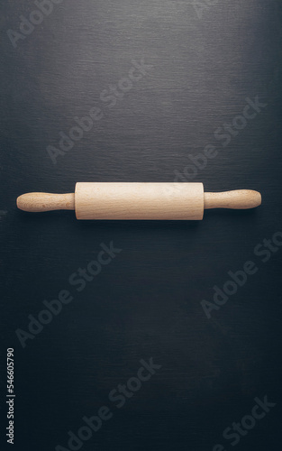 Baking background with flour, eggs, kitchen tools, utensils on dark table. Top view. Flat lay style. Mock up.