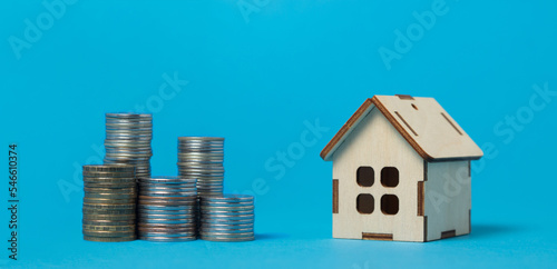 Real estate purchase and sale concept. Real estate services. Bargain home purchase. Small wooden house on a blue background. 