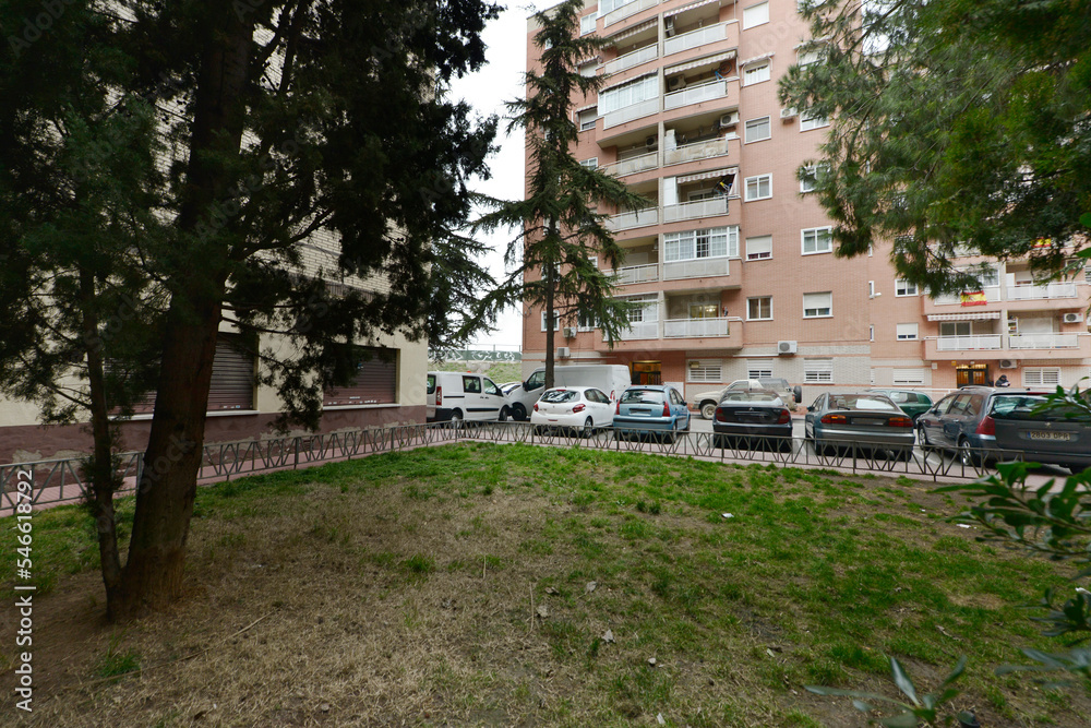 Fototapeta premium Facades of residential houses of light brown exposed brick with lawn gardens and trees