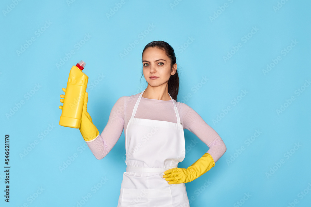 woman in gloves and cleaner apron holding bottle of detergent woman in gloves and cleaner apron holding bottle of detergent