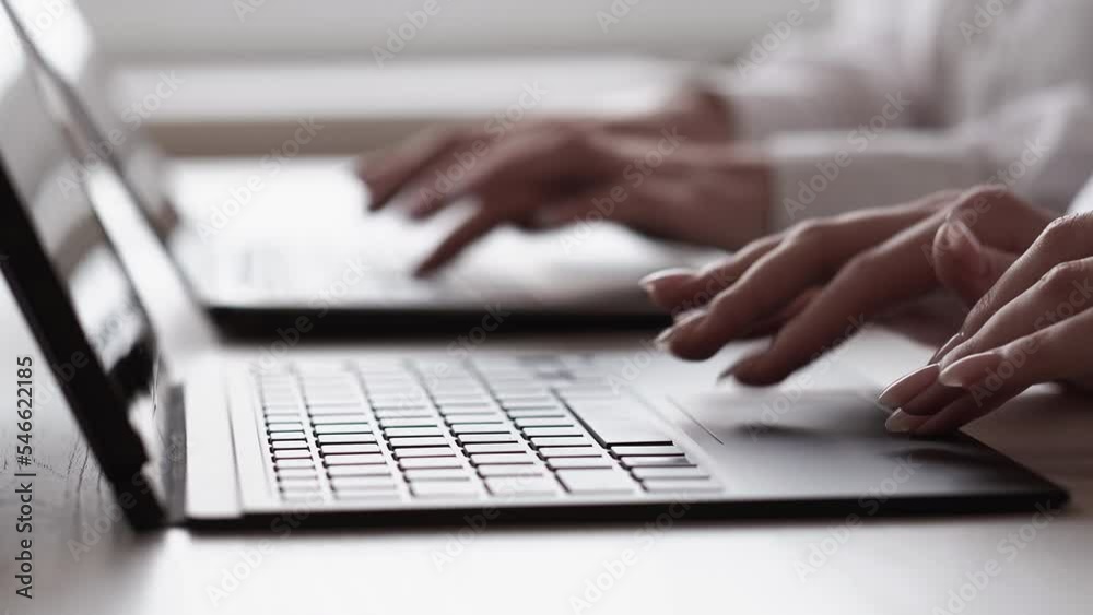 Online work. Digital business. Internet management. Unrecognizable female colleagues hands typing on laptop keyboard at office workplace.
