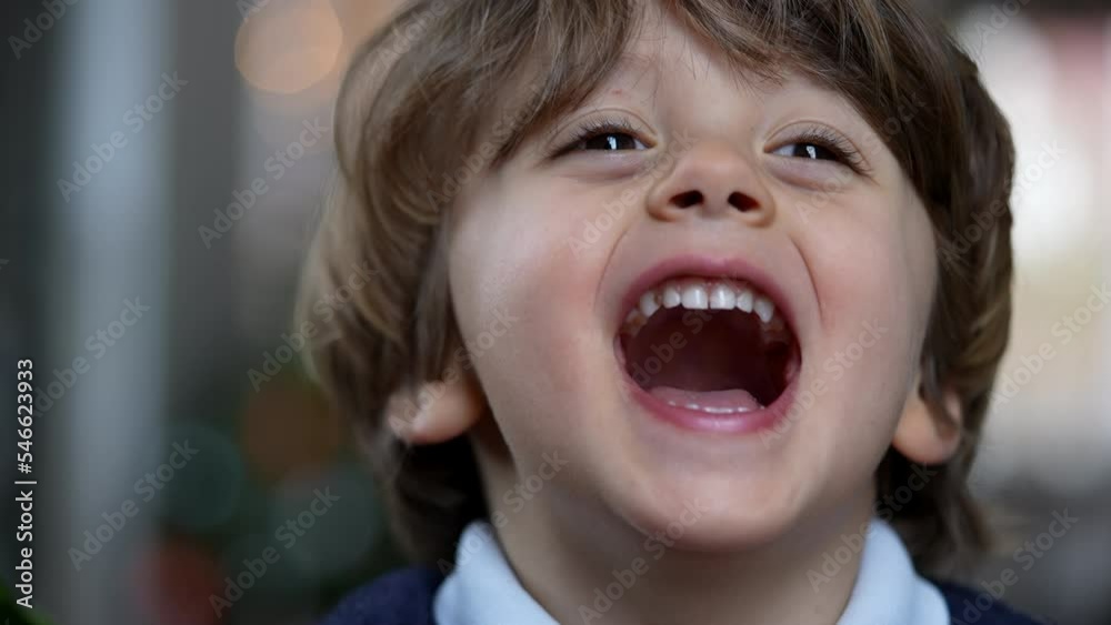 Portrait of a happy baby toddler laughing out loud. Joyful kid face closeup smiling. Authentic real life laugh and smile Portrait of a happy baby toddler laughing out loud. Joyful kid face closeup smiling. Authentic real life laugh and smile