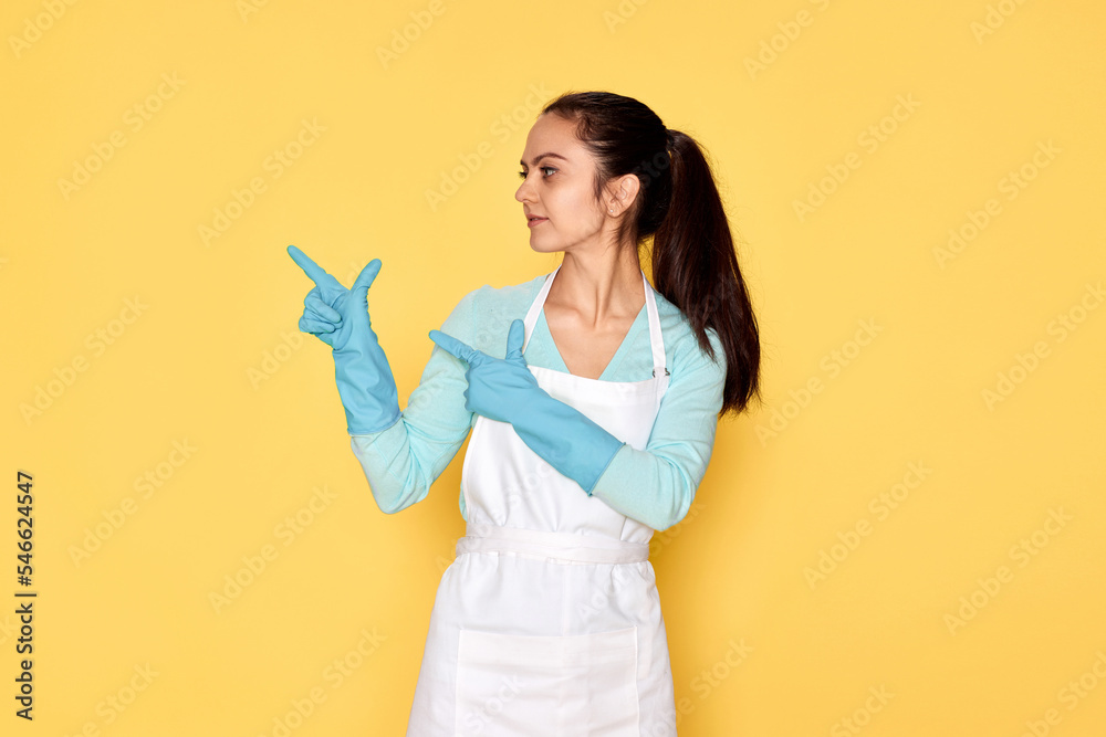 woman in rubber gloves pointing fingers aside at copyspace woman in rubber gloves pointing fingers aside at copyspace
