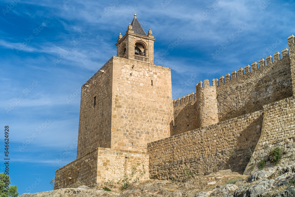 Alcazaba de Antequera. old medieval castle. stone walls, towers, stone buildings. horizontally and vertically, sunlight, blue sky and clouds Alcazaba de Antequera. old medieval castle. stone walls, towers, stone buildings. horizontally and vertically, sunlight, blue sky and clouds