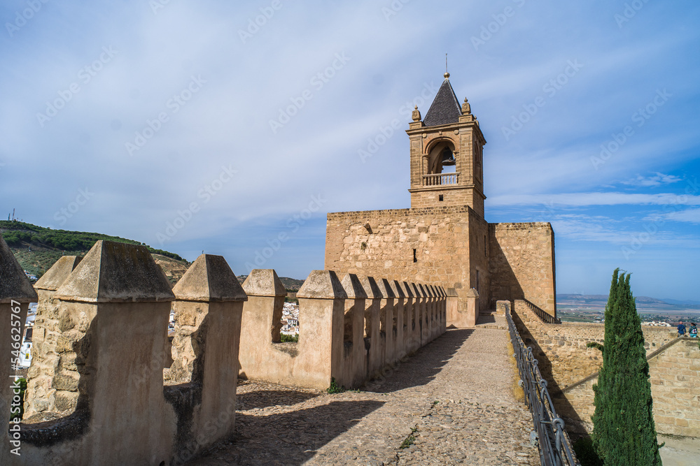 Alcazaba de Antequera. old medieval castle. stone walls, towers, stone buildings. horizontally and vertically, sunlight, blue sky and clouds