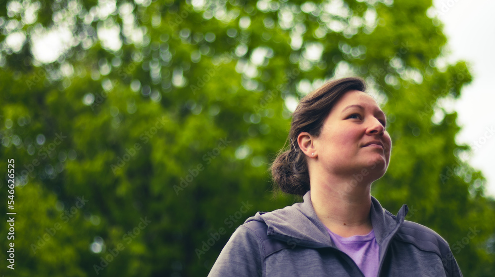 portrait of an ambitious or successful woman looking up and into the distance, self-employed businesswoman, equality, equal pay, ambition, nature background portrait of an ambitious or successful woman looking up and into the distance, self-employed businesswoman, equality, equal pay, ambition, nature background
