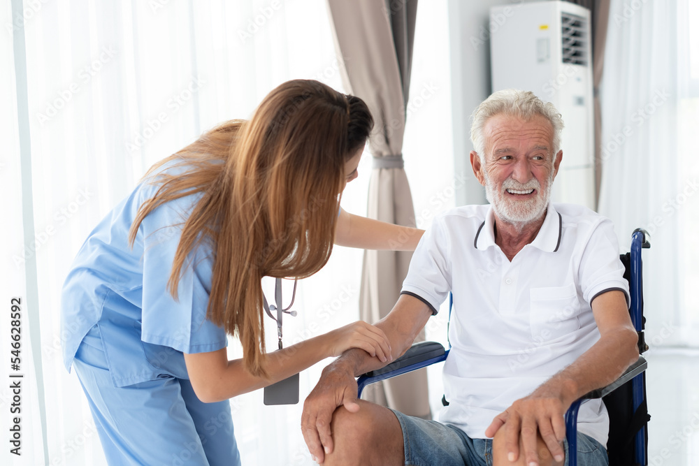 Fototapeta premium Caring nurse with senior man sitting in the bedroom . caucasian man. Discussing. Caring caregiver and senior citizen. Nurse helping senior patient . Young nurse helping elderly man