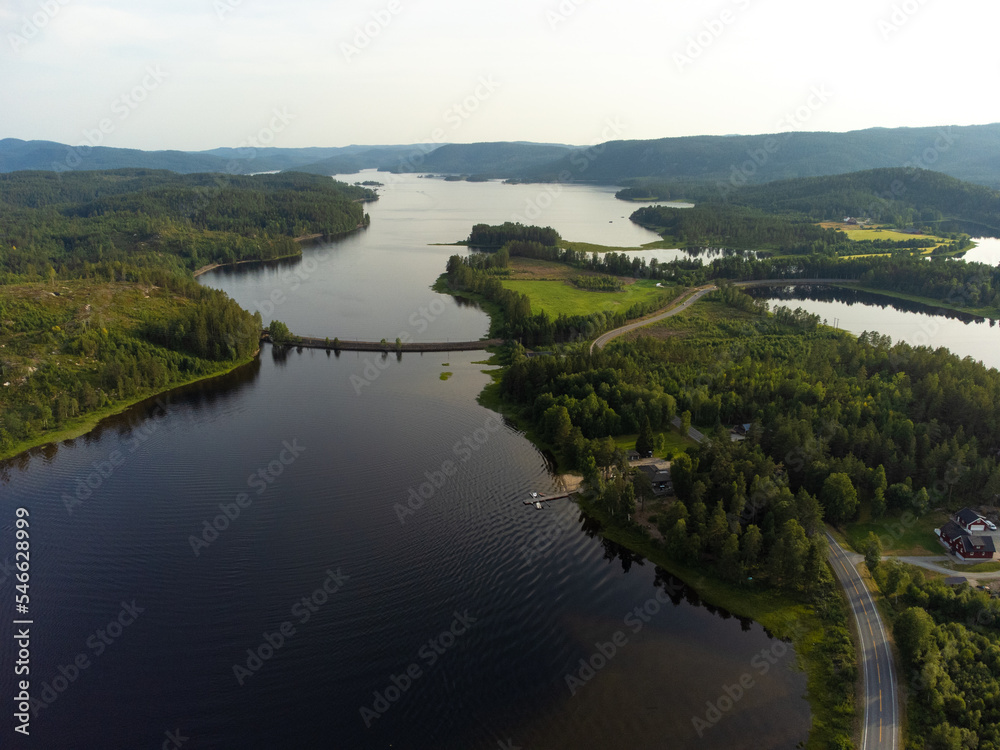 Droneshot of norwegian lake with crossing railway track