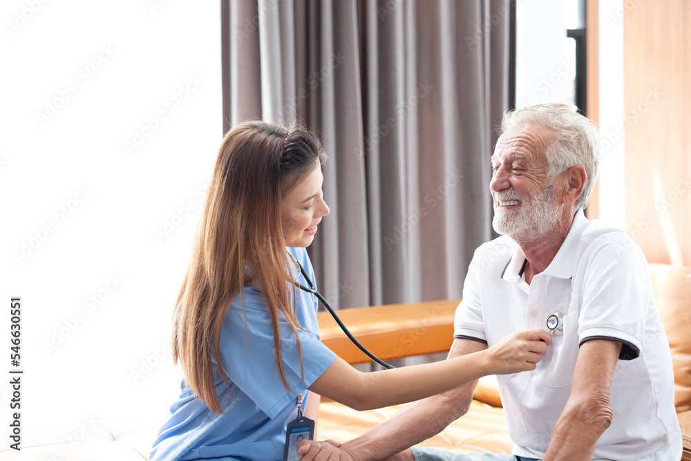 Caring nurse with senior man sitting in the bedroom . caucasian man. Discussing. Caring caregiver and senior citizen. Nurse helping senior patient . Young nurse helping elderly man Caring nurse with senior man sitting in the bedroom . caucasian man. Discussing. Caring caregiver and senior citizen. Nurse helping senior patient . Young nurse helping elderly man