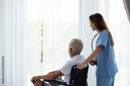 Caring nurse with senior man sitting in the bedroom . caucasian man. Discussing. Caring caregiver and senior citizen. Nurse helping senior patient . Young nurse helping elderly man