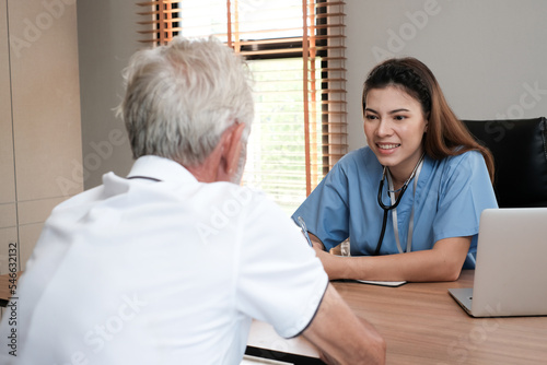 Caring nurse with senior man sitting in the bedroom . caucasian man. Discussing. Caring caregiver and senior citizen. Nurse helping senior patient . Young nurse helping elderly man