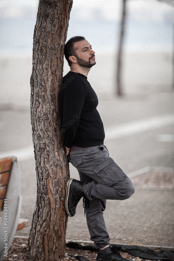 Natural looking guy posing outdoors, wearing casual clothes