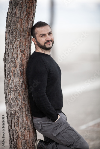 Natural looking guy posing outdoors, wearing casual clothes