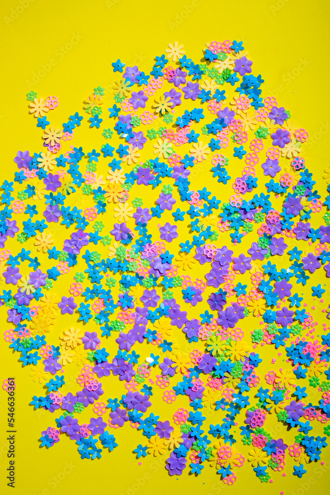 Abstract background of colored flowers on a yellow background