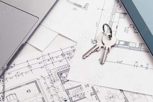 key and architectural blueprint map or drawing of house or future home at landlord real estate agent