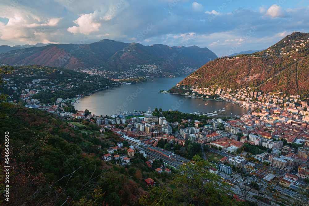 Lake Como and the city of Como, one of the most famous tourist destinations in Italy with the evening lights of an autumn day - September 2022.