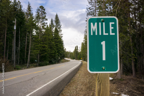 A highway mile 1 marker along a back road photo