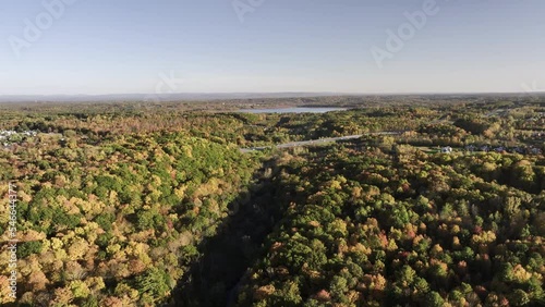 Autumn foliage with highway and lake photo