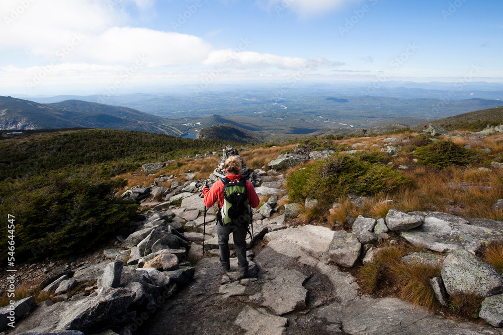 An athletic female hiker hikes the Franconia Ridge Trail. An athletic female hiker hikes the Franconia Ridge Trail.