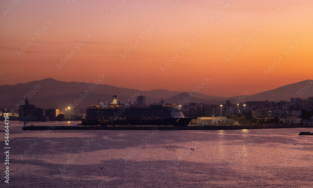 Cruise Ship in Port in Capital City of Athens, Greece. Colorful Sunrise Sky.