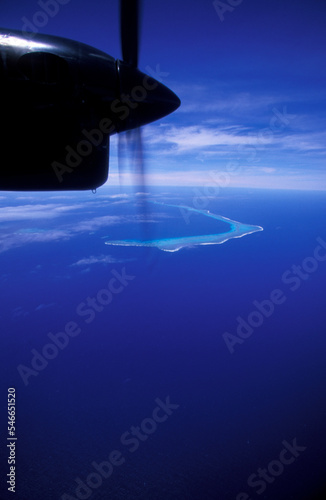 A plane flying over the ocean. photo