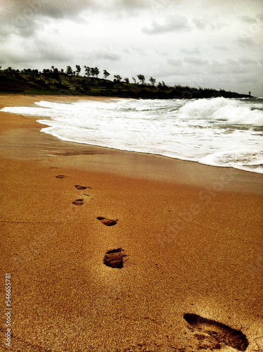 Footsteps in the sand on a beach photo