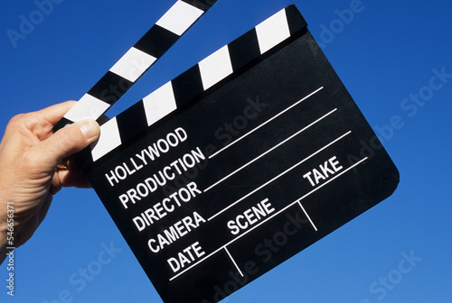 Hand holding clapboard.