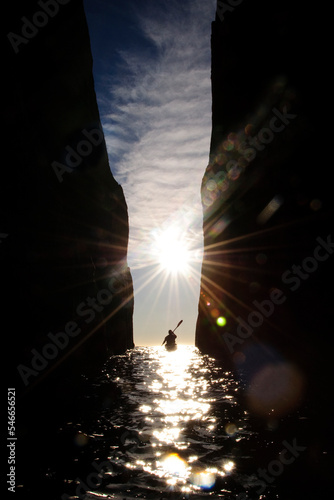 A sea kayaker explores a cave on Schouten Island, Freycinet NP, Tasmania, Australia. photo