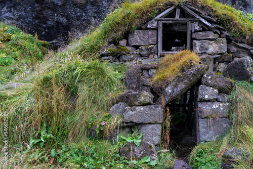 Old hut ruins built form rocks in Iceland with grass covered roof