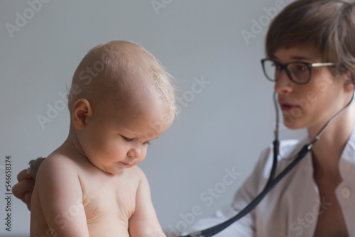 Paediatrician examining baby boy in clinic, Freiburg im Breisgau, Germany photo