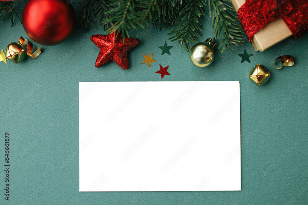 Christmas card flat lay. Modern greeting card mock up with stylish christmas decorations and fir branches on green background. Empty postcard template, space for text. Happy Holidays! Christmas card flat lay. Modern greeting card mock up with stylish christmas decorations and fir branches on green background. Empty postcard template, space for text. Happy Holidays!